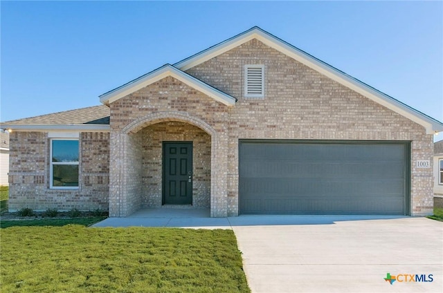 1003 Antelope Trl, Temple, TX 76504 - view of front of property with an attached garage, brick siding, and concrete driveway