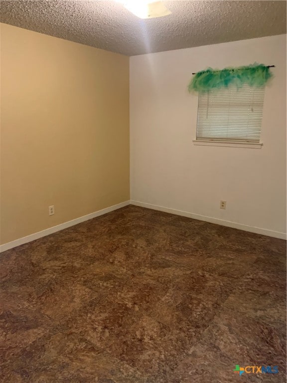 empty room featuring a textured ceiling