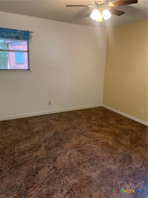 spare room featuring ceiling fan and a textured ceiling