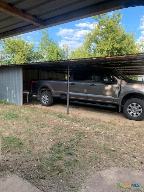 view of vehicle parking with a carport