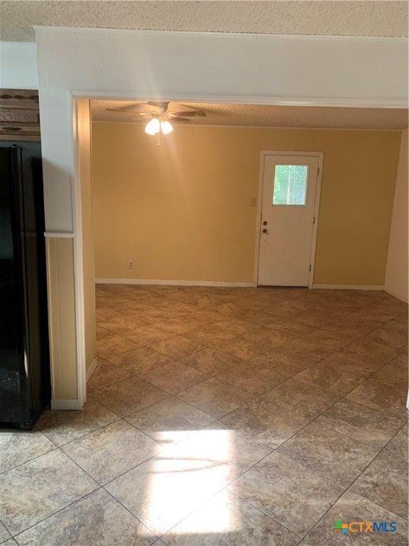 foyer entrance with ceiling fan