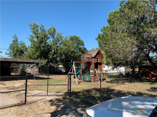 exterior space with a front lawn, a storage unit, and a playground