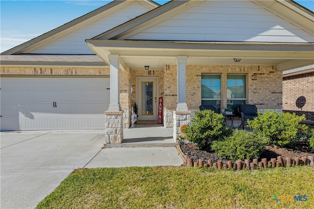 view of front of home featuring a porch and a garage