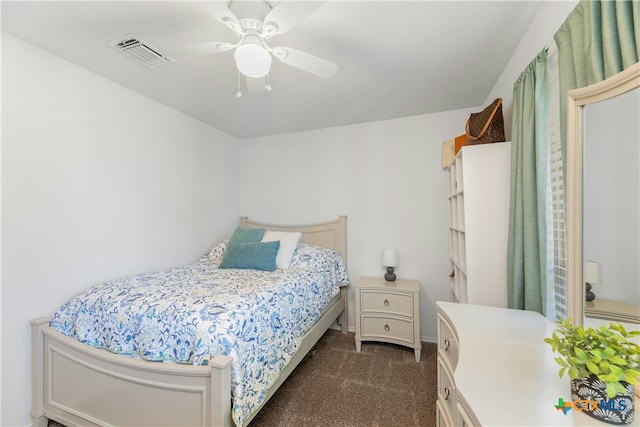 bedroom featuring dark carpet and ceiling fan