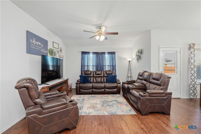 living room featuring ceiling fan, wood-type flooring, and vaulted ceiling