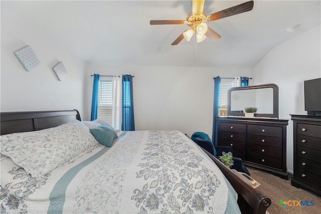 bedroom featuring carpet flooring, ceiling fan, vaulted ceiling, and multiple windows