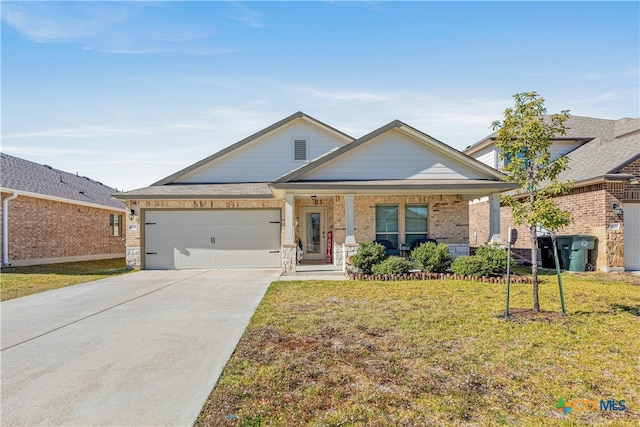 view of front of home with a front lawn, covered porch, and a garage