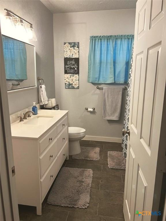 1804 N Goldman St, Victoria, TX 77901 - bathroom with vanity, a textured ceiling, and wood finish floors