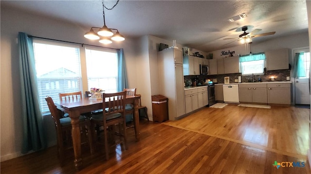 1804 N Goldman St, Victoria, TX 77901 - kitchen with appliances with stainless steel finishes, light wood finished floors, ceiling fan, tasteful backsplash, and light countertops