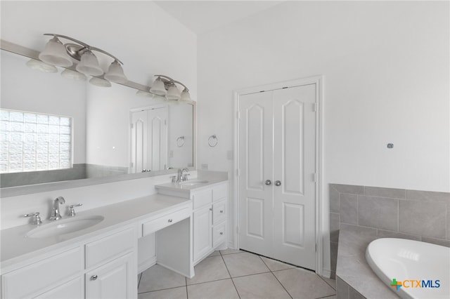 bathroom with vanity, tiled bath, and tile patterned floors