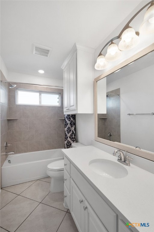 full bathroom with tile patterned flooring, tiled shower / bath, toilet, and vanity