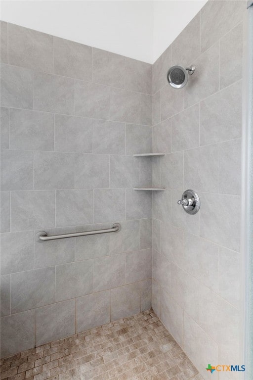 bathroom with a tile shower