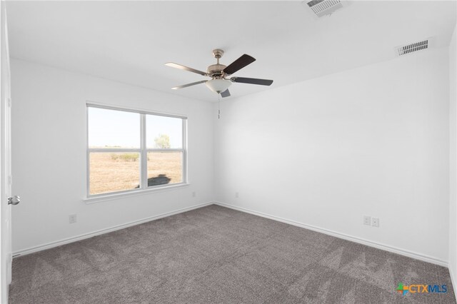 empty room with ceiling fan and carpet floors