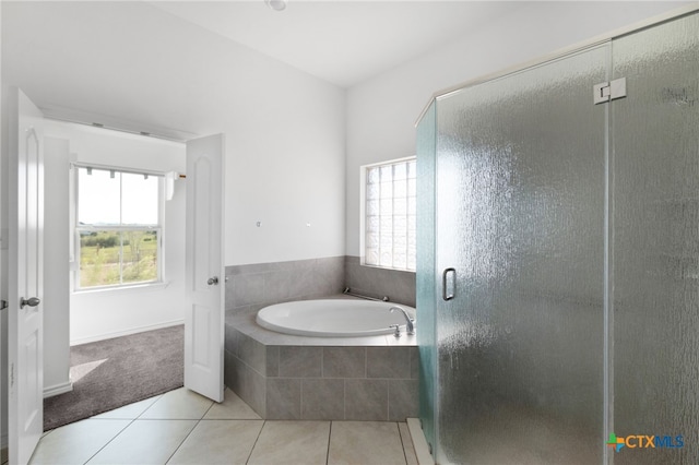 bathroom featuring tile patterned flooring and separate shower and tub