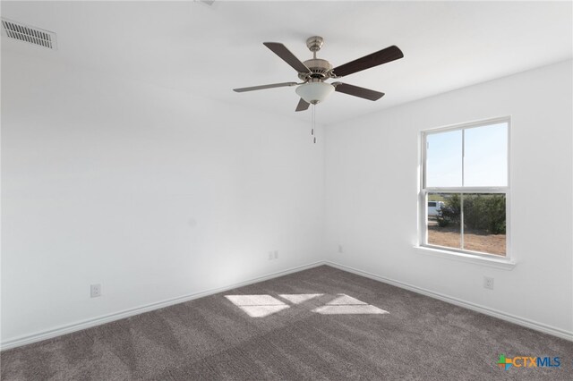 spare room featuring ceiling fan and carpet floors