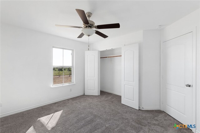 unfurnished bedroom with a closet, carpet flooring, and ceiling fan