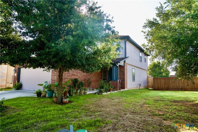 exterior space featuring a garage and a lawn