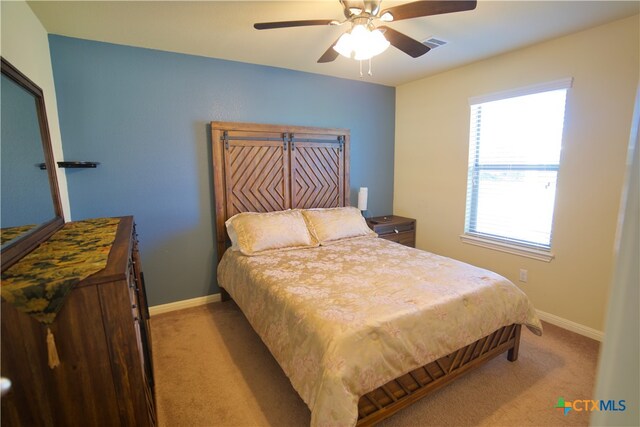 bedroom featuring light carpet and ceiling fan