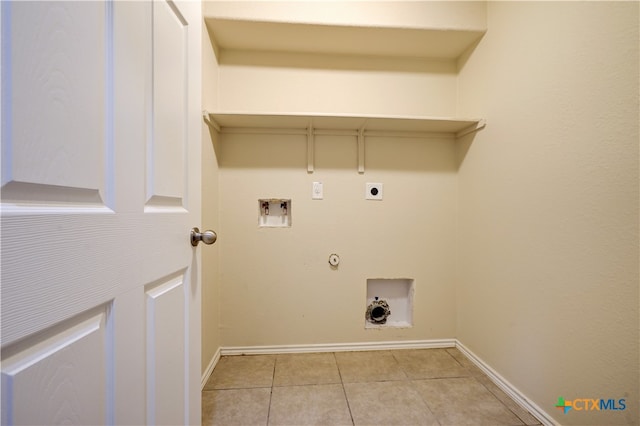 laundry area featuring gas dryer hookup, electric dryer hookup, light tile patterned floors, and washer hookup