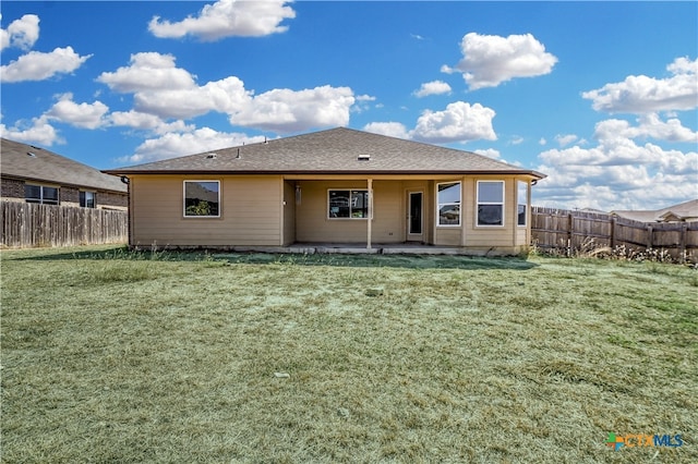 rear view of house with a yard