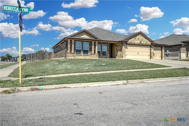 view of front of house featuring a front lawn and a garage