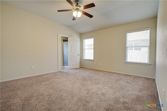 carpeted empty room featuring ceiling fan and lofted ceiling