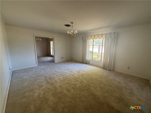 carpeted spare room featuring crown molding and an inviting chandelier