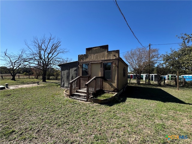 view of side of home with a lawn