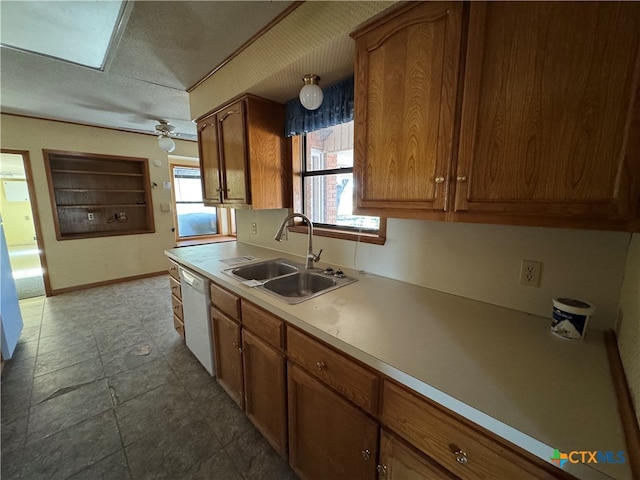 kitchen featuring ceiling fan, sink, white dishwasher, and a healthy amount of sunlight