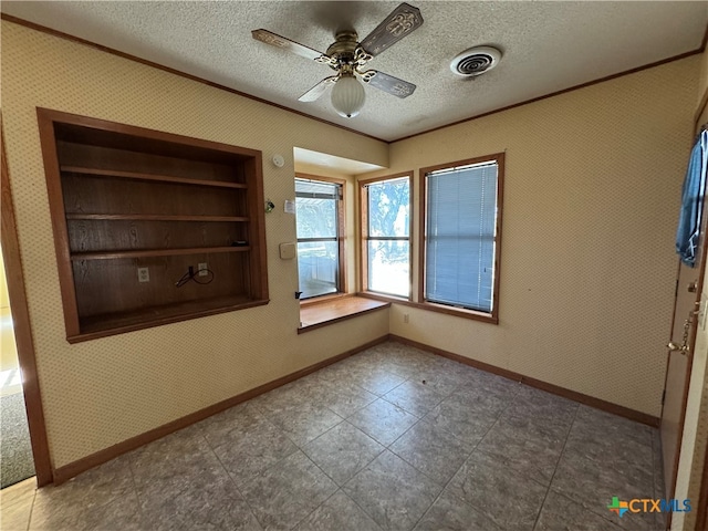 spare room with a textured ceiling and ceiling fan