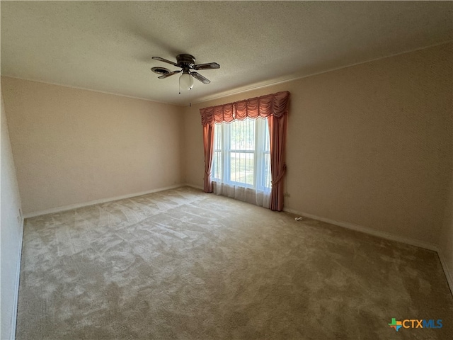 spare room with ceiling fan, carpet floors, and a textured ceiling