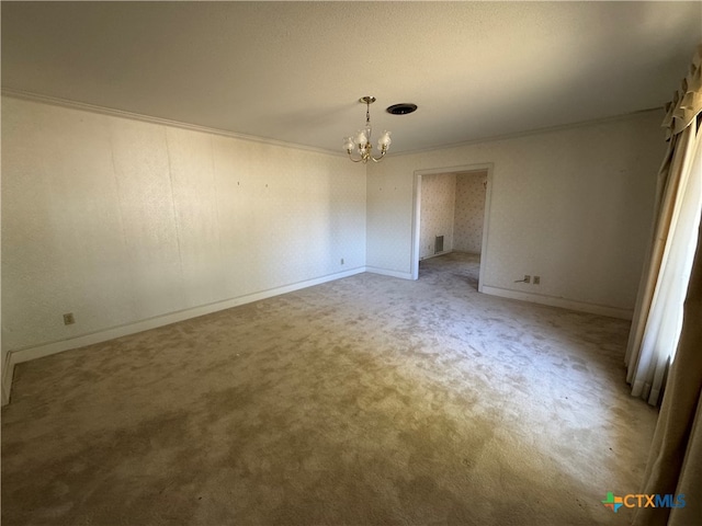 empty room with crown molding, light colored carpet, and an inviting chandelier