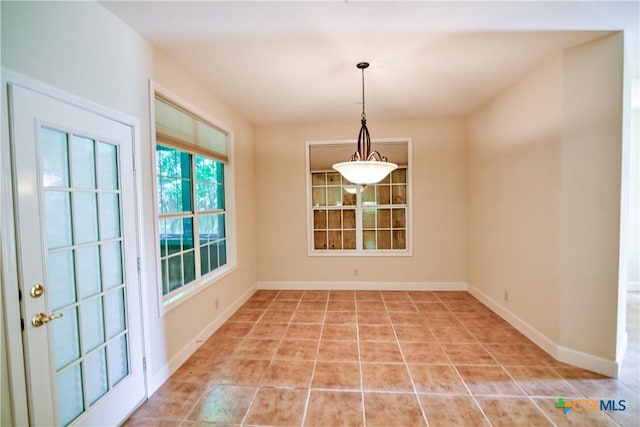 1802 N Vine St, Victoria, TX 77901 - unfurnished dining area with light tile patterned floors and baseboards