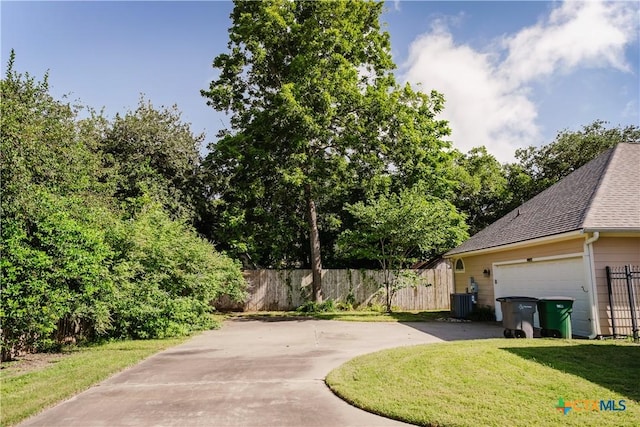 1802 N Vine St, Victoria, TX 77901 - view of yard with driveway and an attached garage
