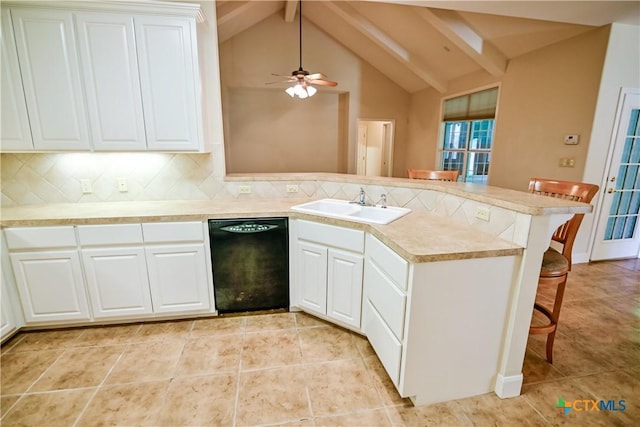 1802 N Vine St, Victoria, TX 77901 - kitchen featuring black dishwasher, a peninsula, tasteful backsplash, a kitchen breakfast bar, and white cabinets