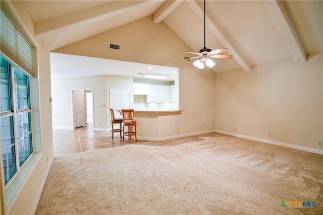 1802 N Vine St, Victoria, TX 77901 - unfurnished living room featuring light carpet, beamed ceiling, ceiling fan, and high vaulted ceiling