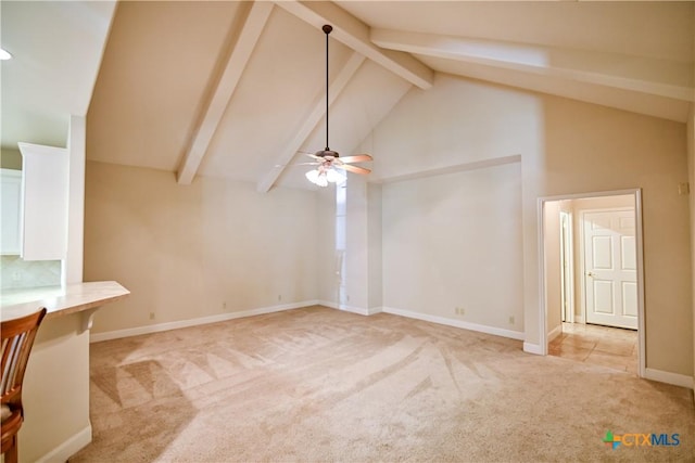 1802 N Vine St, Victoria, TX 77901 - unfurnished living room with light carpet, beamed ceiling, ceiling fan, and high vaulted ceiling