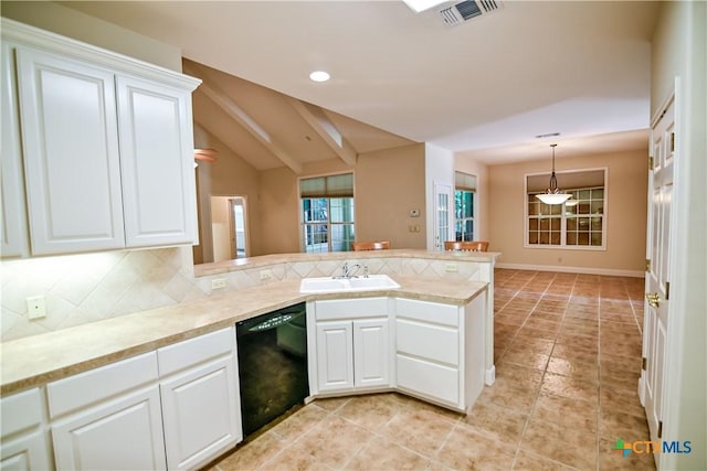 1802 N Vine St, Victoria, TX 77901 - kitchen with dishwasher, a peninsula, backsplash, white cabinets, and recessed lighting