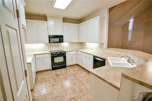 1802 N Vine St, Victoria, TX 77901 - kitchen featuring black appliances, tasteful backsplash, light countertops, and white cabinets