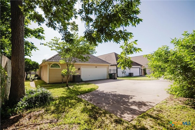 1802 N Vine St, Victoria, TX 77901 - view of front of property featuring concrete driveway, a front lawn, and a garage
