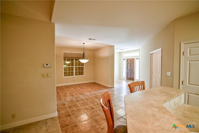 1802 N Vine St, Victoria, TX 77901 - unfurnished dining area featuring baseboards and light tile patterned floors