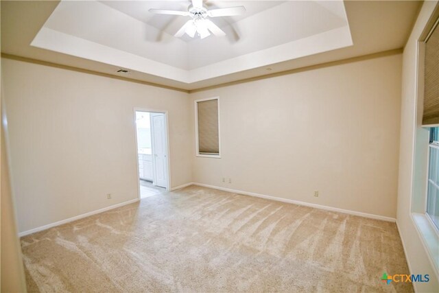 1802 N Vine St, Victoria, TX 77901 - unfurnished room with carpet, a tray ceiling, and a ceiling fan