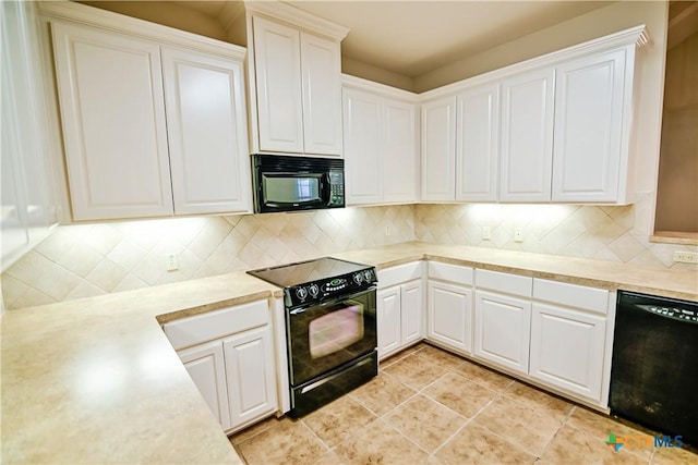 1802 N Vine St, Victoria, TX 77901 - kitchen featuring black appliances, light countertops, tasteful backsplash, and white cabinets