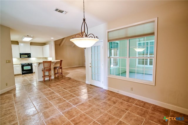 1802 N Vine St, Victoria, TX 77901 - dining area with baseboards and light tile patterned floors