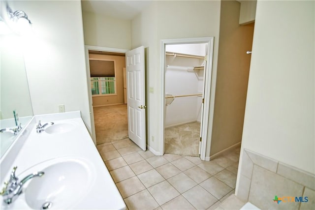 1802 N Vine St, Victoria, TX 77901 - full bath featuring double vanity, tile patterned flooring, and a walk in closet