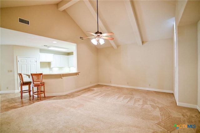 1802 N Vine St, Victoria, TX 77901 - unfurnished living room featuring a ceiling fan, beam ceiling, light carpet, and high vaulted ceiling