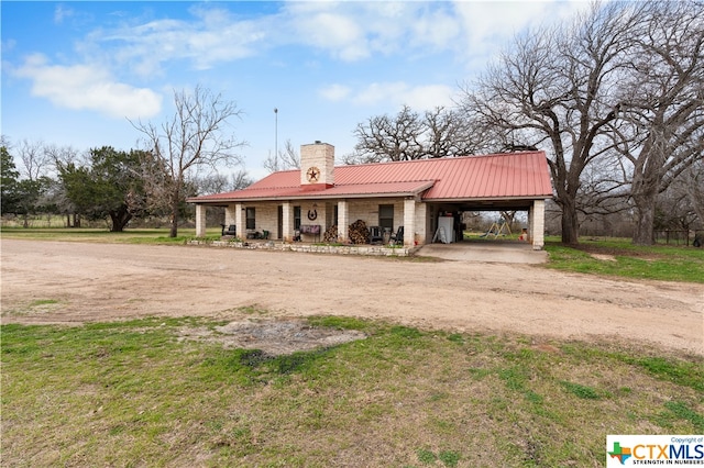 view of front of house featuring covered porch and a carport