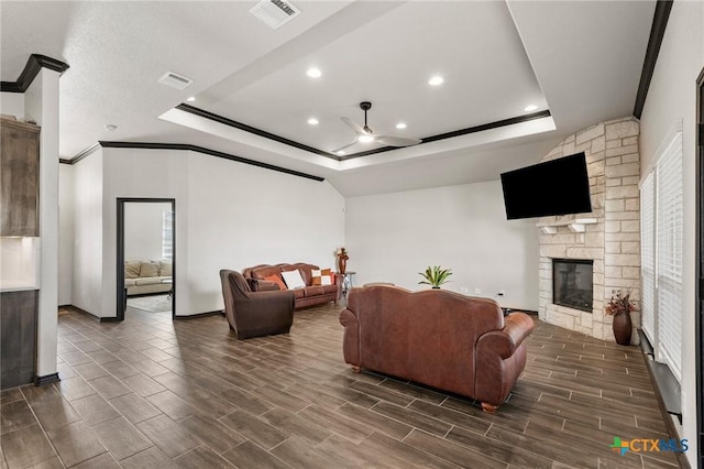 8306 Callahan Dr, Killeen, TX 76542 - living room with a tray ceiling, a ceiling fan, a fireplace, recessed lighting, and healthy amount of natural light