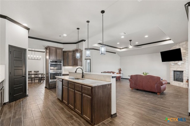 8306 Callahan Dr, Killeen, TX 76542 - kitchen featuring stainless steel appliances, light countertops, dark wood-style flooring, recessed lighting, and a stone fireplace