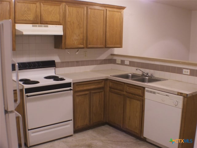 kitchen with tasteful backsplash, sink, and white appliances